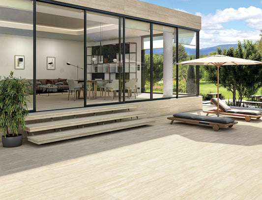 Modern house with large glass windows and a deck area with outdoor furniture. Modern bathroom and living with 600x1200 Travertine look tile walls and floors. Melbourne, Geelong, Shepparton, Ballarat, Bendigo, Mornington, Bellarine, Peninsula tiles. Victoria and Nationwide Delivery. Australia. Parisian. Vives. Attico. Comedor. Paris.