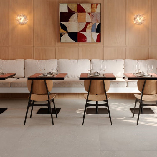 Modern restaurant interior with tables, chairs, and a decorative wall art piece. Modern bathroom and living with 600x600 Pietra Di Sicilia Stone Look Matt Tiles by Marazzi. Melbourne, Geelong, Shepparton, Ballarat, Bendigo, Mornington, Bellarine, Peninsula, Melton, Lara, Sunbury, Warrnambool, Horsham tiles. Victoria and Nationwide Delivery. Australia.