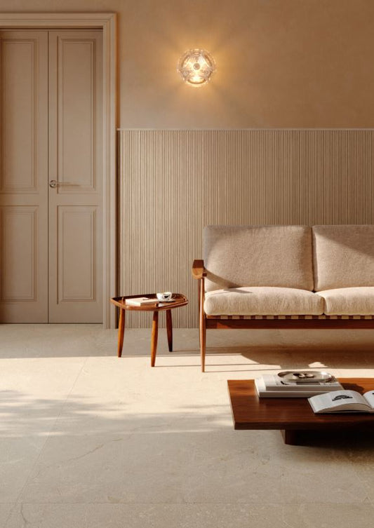 Modern living room with a beige sofa, wooden coffee table, and wall sconce. Modern bathroom and living with 600x600 Pietra Di Sicilia Stone Look Matt Tiles by Marazzi. Melbourne, Geelong, Shepparton, Ballarat, Bendigo, Mornington, Bellarine, Peninsula, Melton, Lara, Sunbury, Warrnambool, Horsham tiles. Victoria and Nationwide Delivery. Australia.