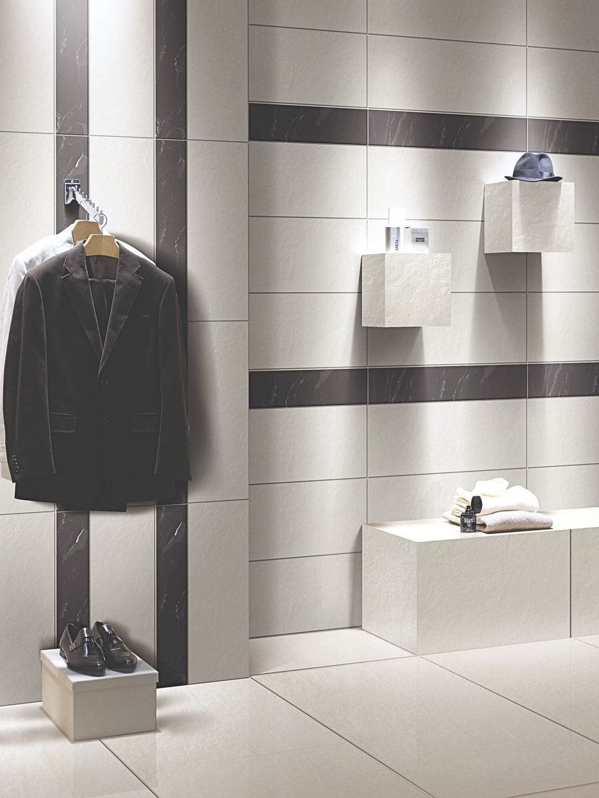 Modern bathroom interior with tiled walls and a suit hanging on a rack. Modern bathroom and living with 300x600 Costa Rock Face Stone Look Bacchus tile walls and floors. Melbourne, Geelong, Shepparton, Ballarat, Bendigo, Mornington, Bellarine, Peninsula, Lara, Melton, Sunbury, Warrnambool tiles. Victoria and Nationwide Delivery. Australia.