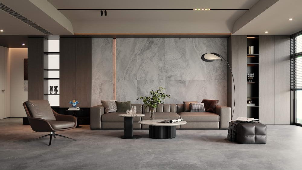 Modern living room with gray sofa, armchair, and coffee table. Modern bathroom and living with 600x600 Travertine look tile walls and floors. Melbourne, Geelong, Shepparton, Ballarat, Bendigo, Mornington, Bellarine, Peninsula tiles. Victoria and Nationwide Delivery. Australia.