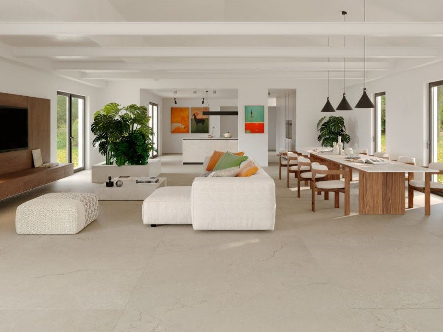 Modern living room with white sofa, wooden dining table, and large windows. Modern bathroom and living with 600x600 Pietra Di Sicilia Stone Look Matt Tiles by Marazzi. Melbourne, Geelong, Shepparton, Ballarat, Bendigo, Mornington, Bellarine, Peninsula, Melton, Lara, Sunbury, Warrnambool, Horsham tiles. Victoria and Nationwide Delivery. Australia.