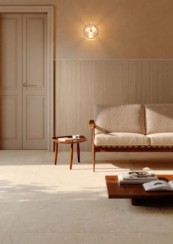 Modern living room with a beige sofa, wooden coffee table, and wall sconce. Modern bathroom and living with 600x600 Pietra Di Sicilia Stone Look Matt Tiles by Marazzi. Melbourne, Geelong, Shepparton, Ballarat, Bendigo, Mornington, Bellarine, Peninsula, Melton, Lara, Sunbury, Warrnambool, Horsham tiles. Victoria and Nationwide Delivery. Australia.